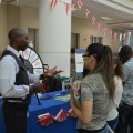 Financial Aid Counselor Cleones Fleurima discusses options with prospective students at the Carnival of Majors.