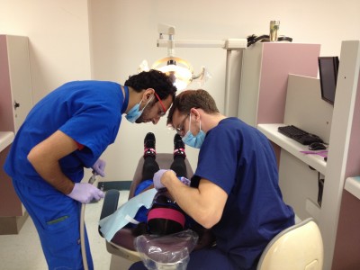 Nova Southeastern University dental students provide pro bono dental services for a child as part of Give Kids a Smile Day