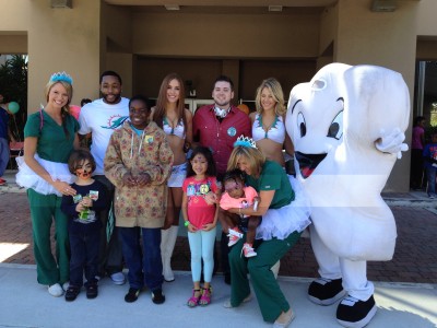 More than 1,000 attendees at Nova Southeastern University College of Dental Medicine’s Give Kids a Smile Day enjoyed a fun carnival atmosphere with Miami Dolphins player Marcus Thigpen and cheerleaders, face painters, a clown, magicians, music, and “Timmy the Tooth”