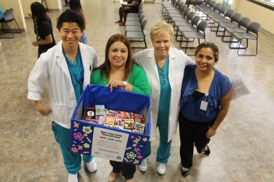 Ricky Wong, NSU Florida Student Nurses Association representative; Patricia Ortiz from Immokalee Clinic; Terry Ogilby, Ph.D., M.S.N., M.P.H., RN, clinical director and associate professor, NSU’s College of Nursing; and Yerania Lopez from Immokalee Clinic showcase the bandages collected and donated by the students