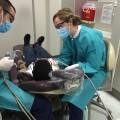 Wade McDaniel and Annie Shaffer, second year students at NSU’s College of Dental Medicine, treat a patient at NSU’s Give Kids a Smile Day