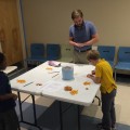 Jeffrey Lyons, Ph.D., assistant professor at the Halmos College of Natural Sciences and Oceanography, works with children at a STEM Programs for Children session at the Alvin Sherman Library.
