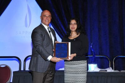 Patrick J. Geraghty, chairman of the board of directors and chief executive officer of Florida Blue, presents a Sapphire Award to Ana Karina Mascarenhas, B.D.S., M.P.H., Dr.P.H., associate dean of research of NSU’s College of Dental Medicine, for the Smiles Across Miami program.