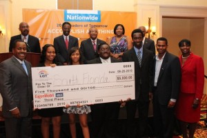 The team of students representing South Florida in the Leaders of Tomorrow® Case Competition held at NSU stand with their check towards scholarships awarded for finishing in third place.  