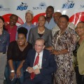 Prime Minister Seaga poses with students and attendees.