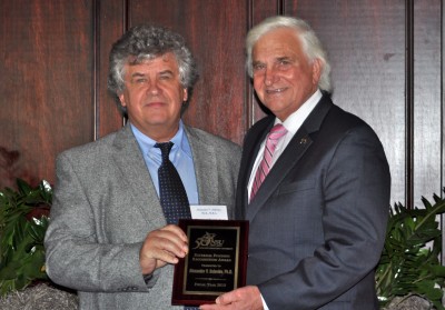 Alexander Soloviev, Ph.D., professor, NSU Oceanographic Center, and George Hanbury II, Ph.D., NSU president, with an External Funding Recognition plaque.