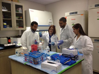 Jean J. Latimer, Ph.D. (center left), conducts research in her NSU laboratory with Ph.D. students Manasi Pimpley, Omar Ibrahim, and Homood As Sobeai