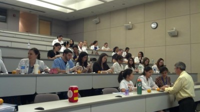 Goar Alvarez, Pharm.D., instructs pharmacy students on proper injection techniques using oranges