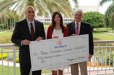 David Ross, senior vice president relationship manager of SunTrust, and Kimberly Cagiano, senior vice president division sales and marketing director, present a $50,000 donation to Nova Southeastern University President George L. Hanbury II, Ph.D. as part of their larger investment in the university.