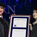: U.S. Rep. Mario Diaz-Balart poses with the Doctor of Humane Letters, Honoris Causa, that he received as part of Nova Southeastern University's Health Professions Division Commencement ceremonies alongside Jacqueline Travisano, M.B.A., C.P.A., NSU executive vice president and chief operating officer