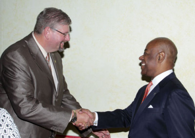 John Riggs, D.B.A, associate P\professor of Marketing is greeted by Hon. Obie Whilchcombe, Minister of Tourism during the closing ceremony.