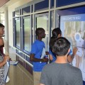Student Ambassador Steven Alcide shows guests the interactive screens at the University Center