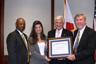 Following his Distinguished Lecture Series presentation, Joseph Farrell (right), is recognized by (from l. to r.) Preston Jones, dean of the H. Wayne Huizenga College of Business and Entrepreneurship; Bridget Guerrero, president of the Graduate Student Business Association; and NSU President Doctor George Hanbury. 