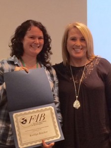 Kaitlyn Brucker, left, an M.S. in Marine Biology candidate at the Halmos College of Natural Sciences and Oceanography, receives an award from Julianne Knight Gray, president of the Florida Association of Benthologists.