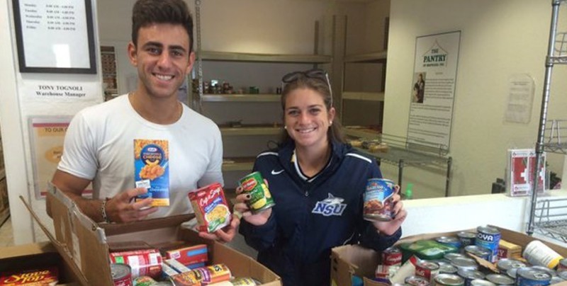 Student-athletes and athletic staff collect canned goods to feed the elderly.