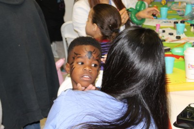 A young boy waiting to be seen at the dental clinic at Nova Southeastern University's College of Dental Medicine gets his face painted. The face-painting was part of the school's national kickoff event for Give Kids A Smile Feb. 5.