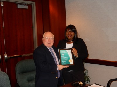 Fred Lippman, R.Ph., Ed.D., NSU Health Professions Division chancellor, accepts an award from Karlyn Emile, director of Special Olympics Florida-Healthy Community