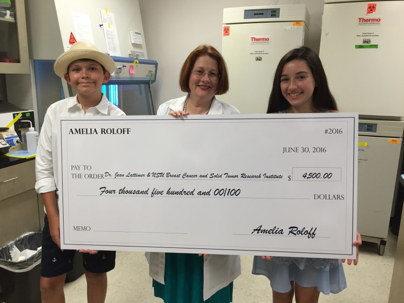Joined by C3 for Change founder Chase Sweers (left), Amelia Roloff (right) presents a $4,500 donation to Dr. Jean Latimer (center) to support breast cancer research at NSU’s AutoNation Institute for Breast and Solid Tumor Cancer Research.