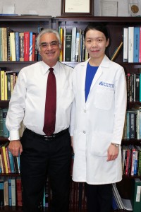 Dean Loshin congratulating Dr. Hua Bi.