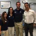 Physical therapy second-year students, from left, Nina Coloso, Courtney Cave, and Michael Jones, along with Ovidio Olivencia, D.P.T., PT, OCS, assistant professor, are shown at a community event where they were promoting the NSU program.