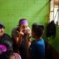 Joanie Gavin sees children in the clinic while a local Guatemalan volunteer looks on curiously.