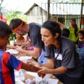 Aliya Chaudhry and Chaz Kisgeropolous entertain children in Guatemala by drawing on their arms during a break.