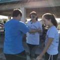 A speech-language pathology and physical therapy student work together to assist a participant with an exercise.