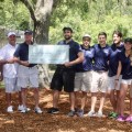 Fins on the Fairway Student Committee presents a check for $8600 to Fairways for Warriors.