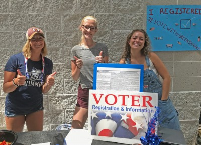 Club members Emily Melhop, Alexis Good and Leeza Abramov running the voter registration table.